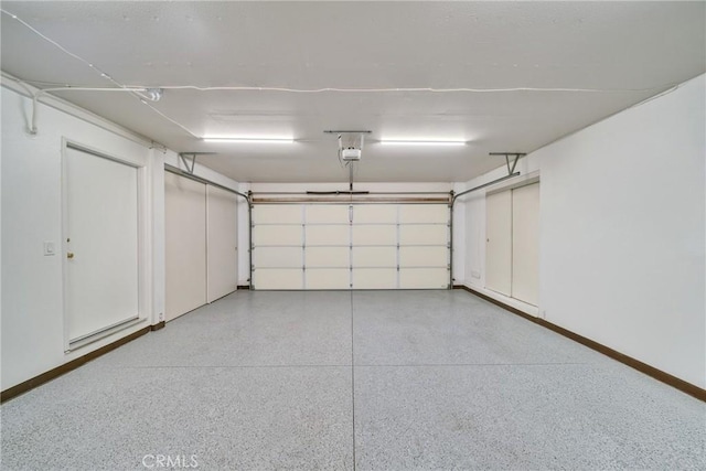 garage featuring baseboards and a garage door opener