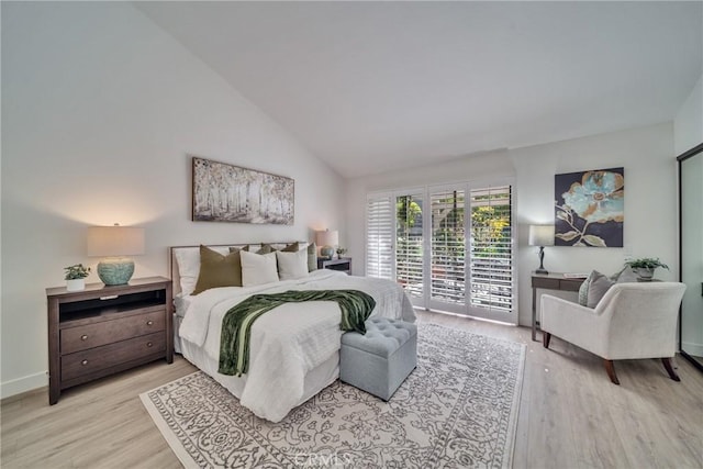 bedroom featuring light wood-type flooring, access to outside, high vaulted ceiling, and baseboards