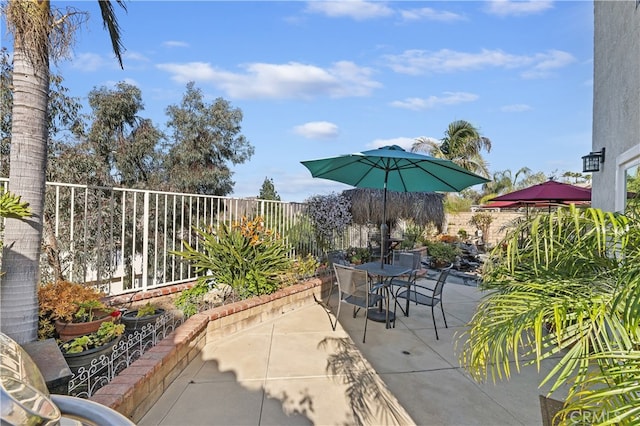 view of patio with outdoor dining area and a fenced backyard