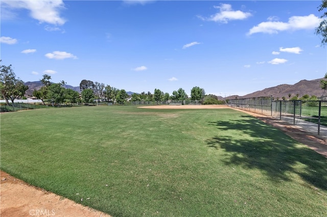 view of property's community featuring fence and a mountain view