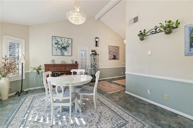 dining area featuring baseboards, visible vents, beamed ceiling, an inviting chandelier, and a brick fireplace