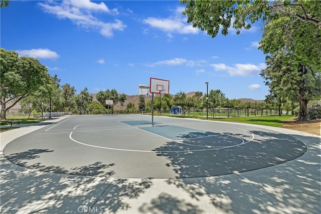 view of basketball court featuring community basketball court and fence