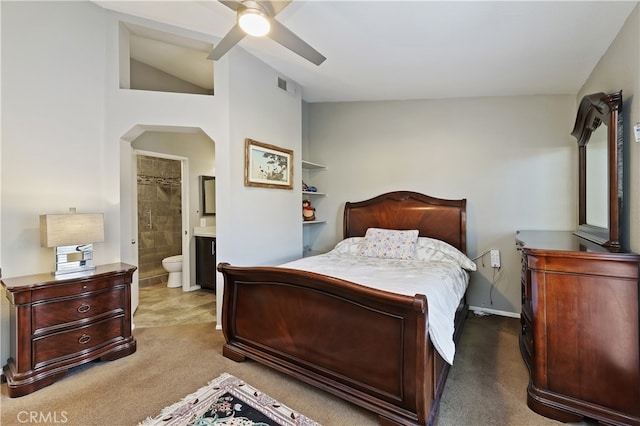 bedroom featuring arched walkways, carpet flooring, connected bathroom, and visible vents