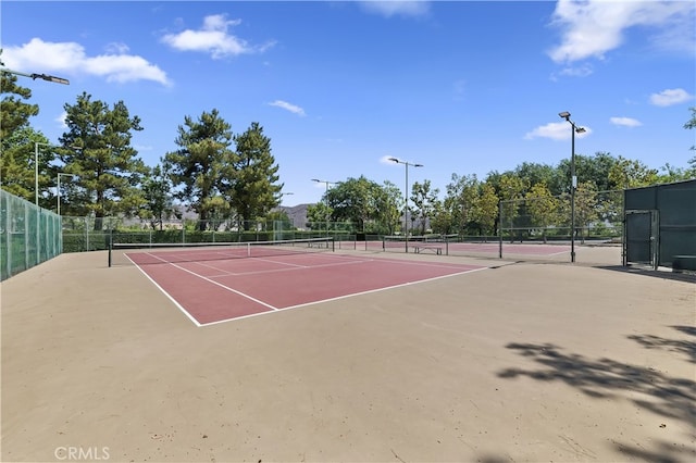 view of sport court featuring fence