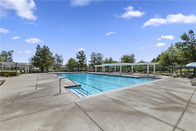 pool featuring a patio area, fence, and a pergola