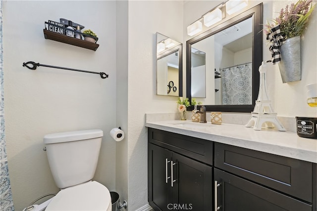 full bathroom with visible vents, vanity, and toilet