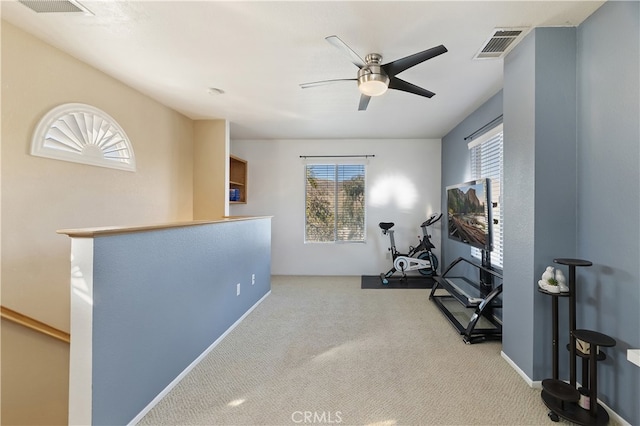 workout area with ceiling fan, carpet flooring, and visible vents