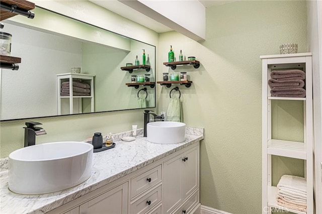 full bath with double vanity and a sink