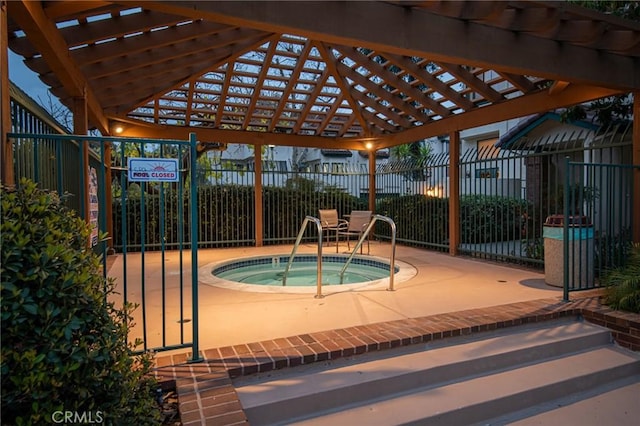 view of pool featuring a hot tub and fence