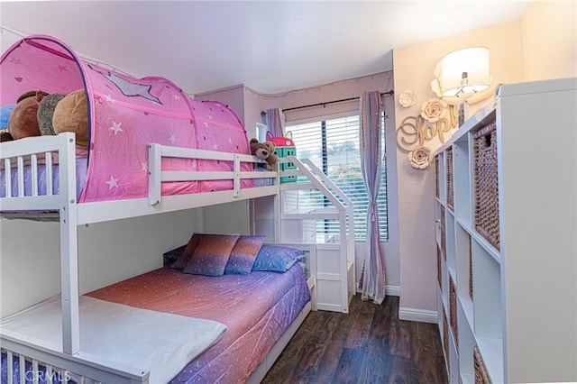 bedroom with baseboards and wood finished floors