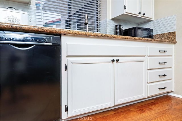 kitchen featuring dishwasher, stone countertops, and white cabinets