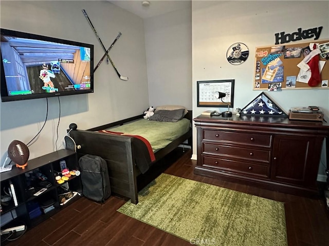 bedroom with dark wood-style floors