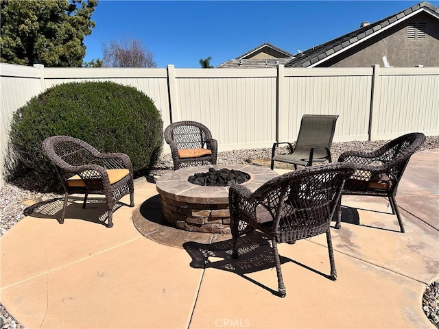 view of patio with fence private yard and a fire pit