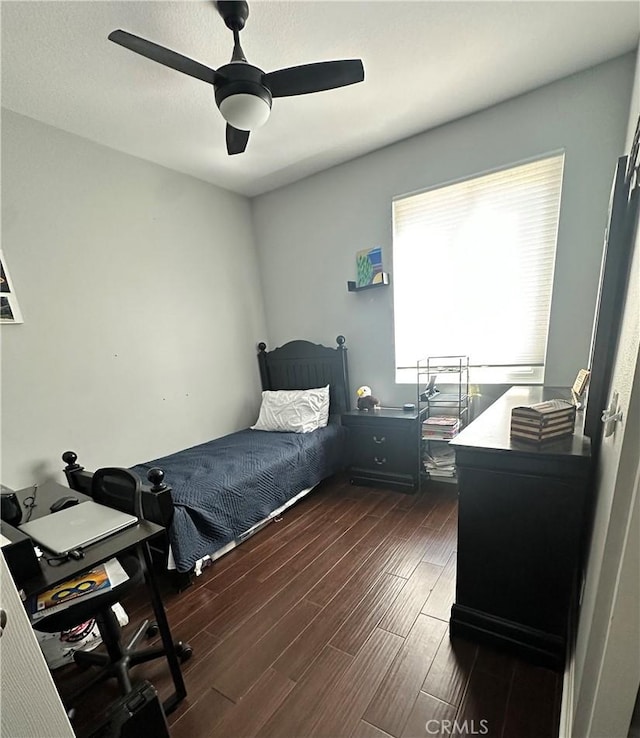 bedroom featuring dark wood-type flooring and ceiling fan