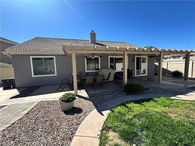 back of house featuring a patio, fence, a pergola, and a tiled roof