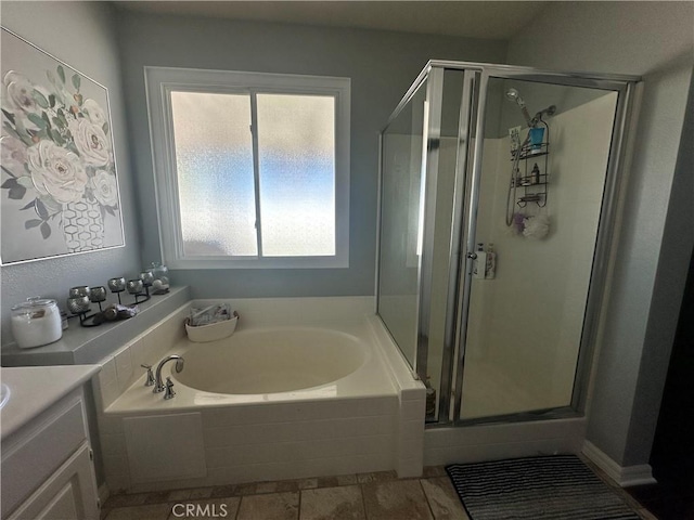 bathroom featuring vanity, a garden tub, and a stall shower