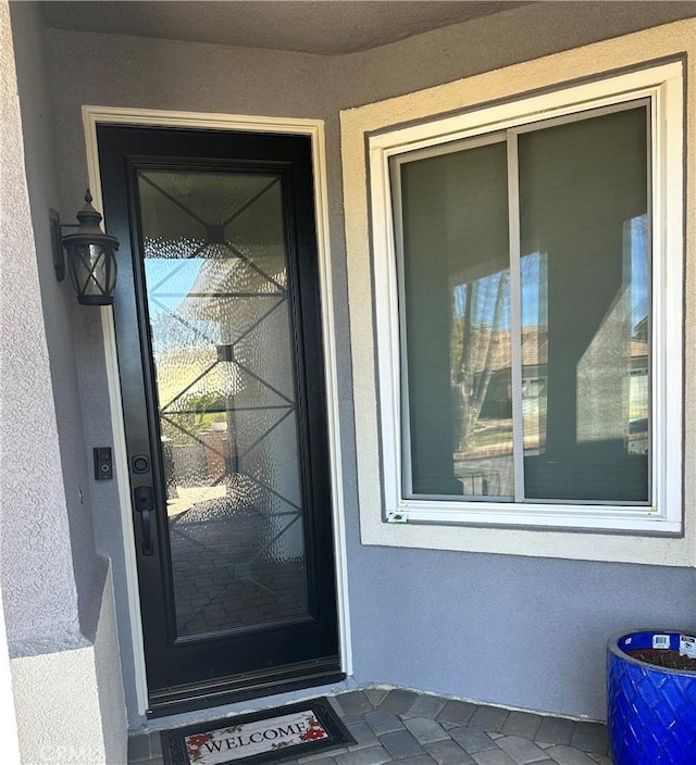 doorway to property with stucco siding