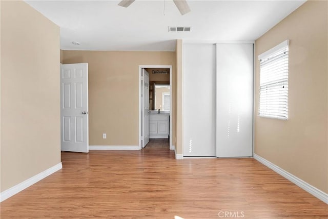 unfurnished bedroom with visible vents, baseboards, ceiling fan, light wood-style floors, and a closet