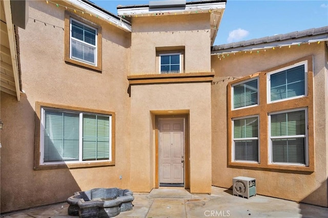 exterior space with a patio and stucco siding