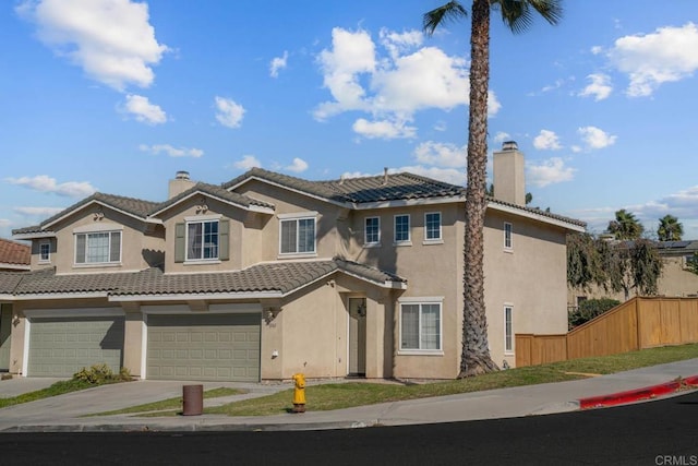 view of front of home with fence, concrete driveway, a tiled roof, stucco siding, and a chimney