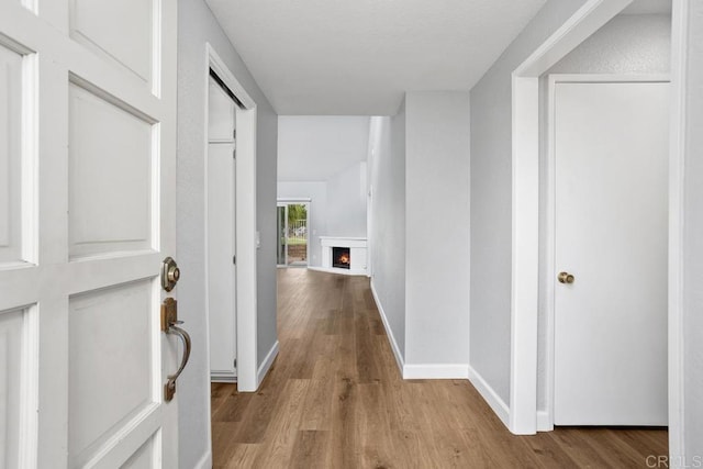 hall with wood finished floors and baseboards