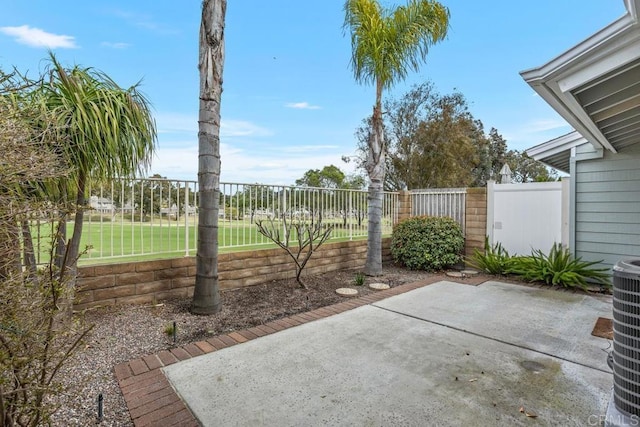 view of patio with a fenced backyard and central air condition unit