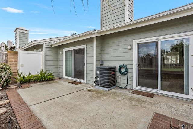 view of patio / terrace featuring central air condition unit and fence