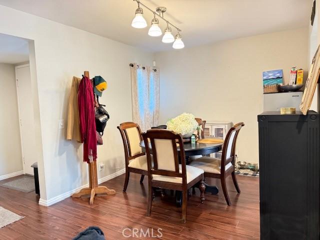 dining room with baseboards and wood finished floors