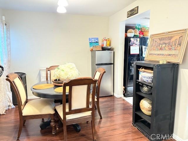 dining room featuring baseboards and wood finished floors