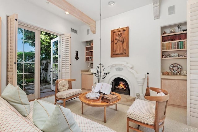 sitting room with visible vents, carpet floors, beam ceiling, recessed lighting, and a lit fireplace