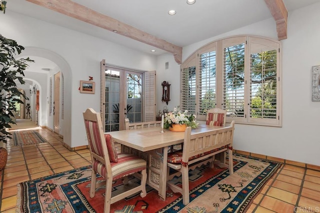 tiled dining room featuring arched walkways, beamed ceiling, recessed lighting, and baseboards