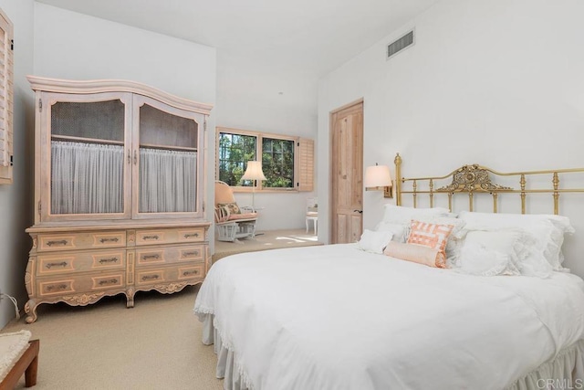 bedroom featuring visible vents and light carpet