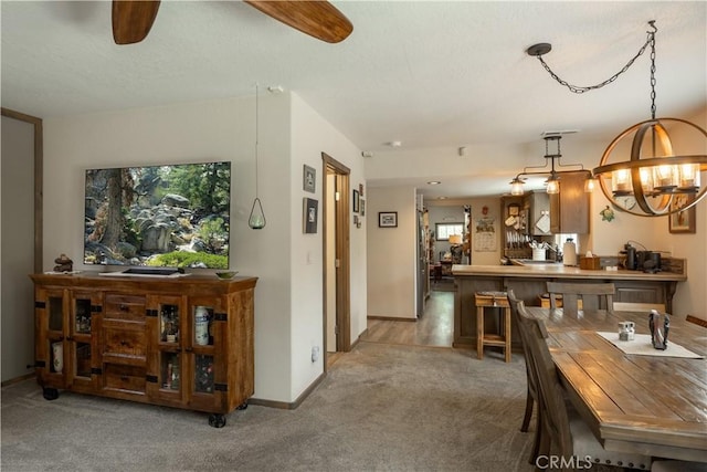 dining area with carpet floors, ceiling fan, and baseboards