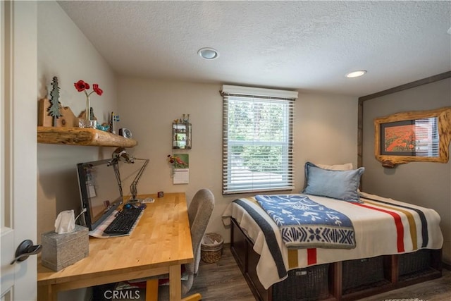 bedroom with a textured ceiling, wood finished floors, and recessed lighting