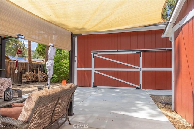 exterior space featuring an outbuilding and fence