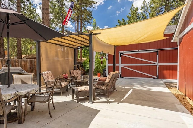 view of patio / terrace with an outbuilding, outdoor dining area, fence, an outdoor living space, and a pergola