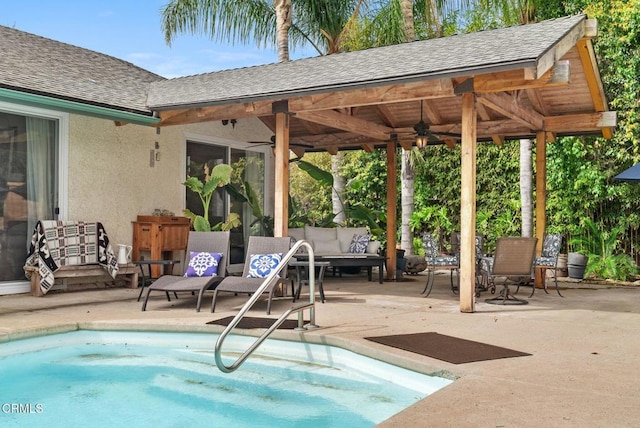 view of swimming pool featuring a patio, outdoor lounge area, and a ceiling fan