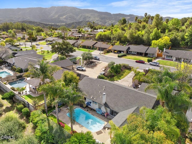 drone / aerial view featuring a residential view and a mountain view