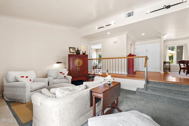 living room featuring baseboards, visible vents, a wealth of natural light, and recessed lighting