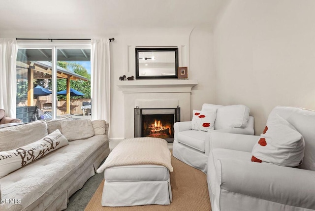 living area with a lit fireplace