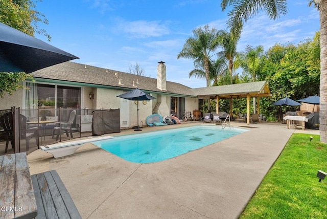 view of swimming pool with a fenced in pool and a patio