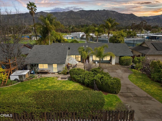 aerial view at dusk featuring a mountain view