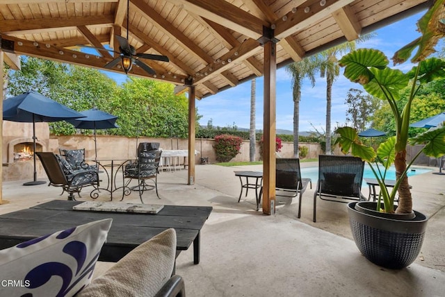 view of patio with a gazebo, outdoor dining area, a fenced backyard, and a fenced in pool