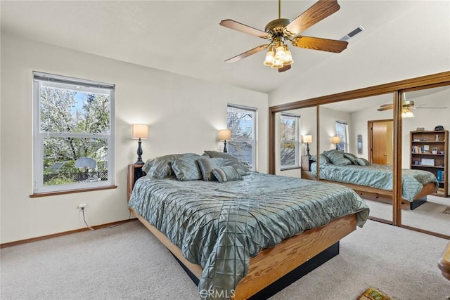 carpeted bedroom featuring baseboards, visible vents, a ceiling fan, vaulted ceiling, and a closet