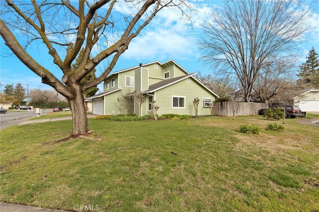 view of property exterior featuring a garage, a yard, and fence