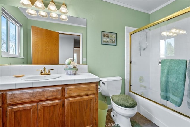 full bathroom with toilet, enclosed tub / shower combo, tile patterned flooring, crown molding, and vanity