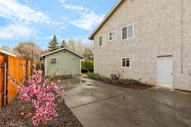 back of house featuring a patio area, fence, and stucco siding