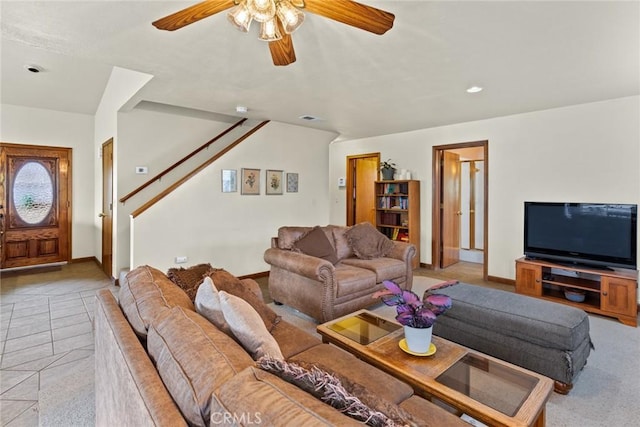 living room featuring ceiling fan, light tile patterned floors, visible vents, and baseboards