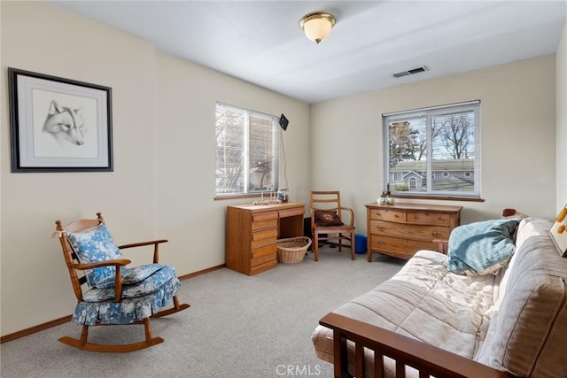 living area with carpet flooring, visible vents, and baseboards