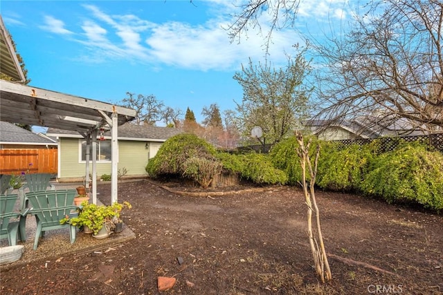 view of yard with fence and a pergola